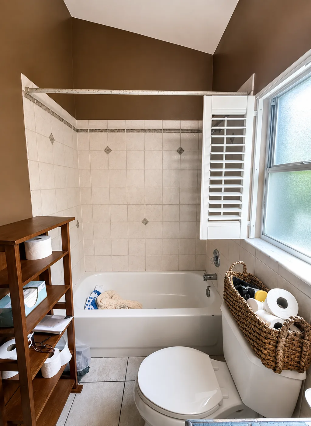 Bathroom remodel replacing dated beige wall tile with large-format porcelain tile, a new soaking tub, tiled niche and wood-look vinyl plank flooring - Before